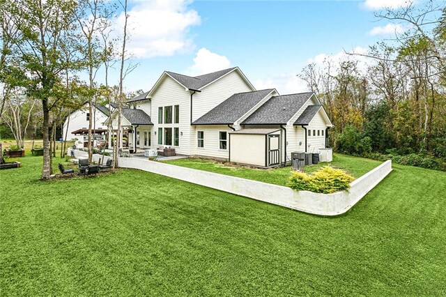 rear view of property featuring a pergola, a patio area, ceiling fan, and exterior fireplace