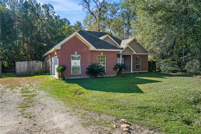 view of front of home with a front lawn and a garage