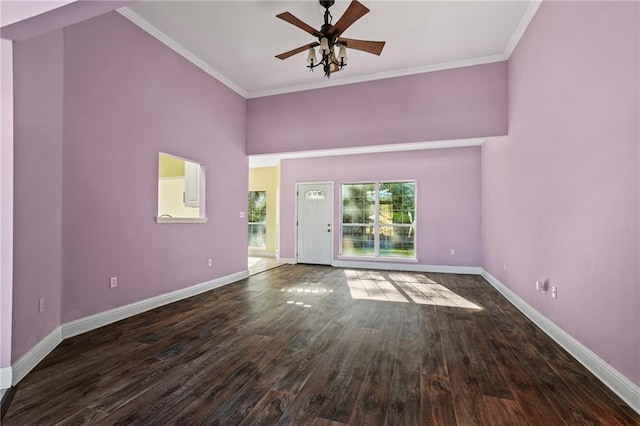 unfurnished living room with ceiling fan, dark hardwood / wood-style floors, and ornamental molding