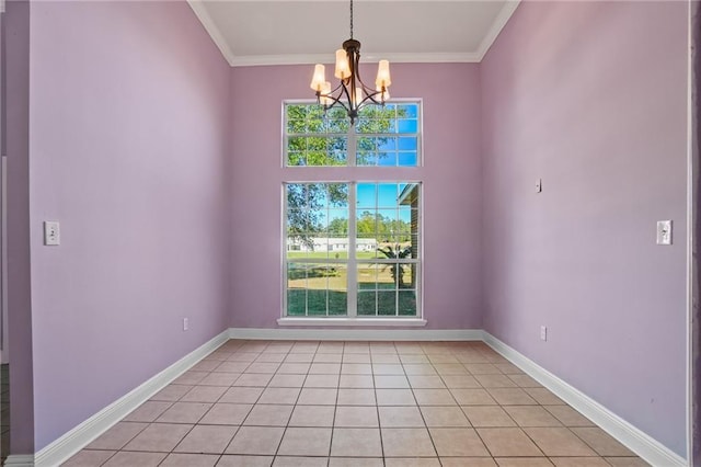 unfurnished room with a notable chandelier, ornamental molding, and light tile patterned floors