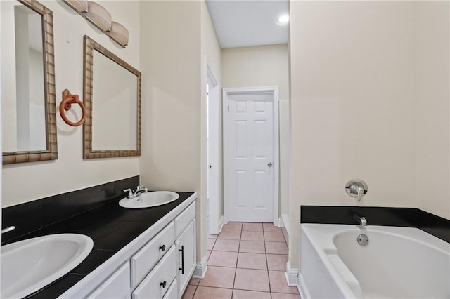 bathroom with tile patterned flooring, vanity, and a bathtub