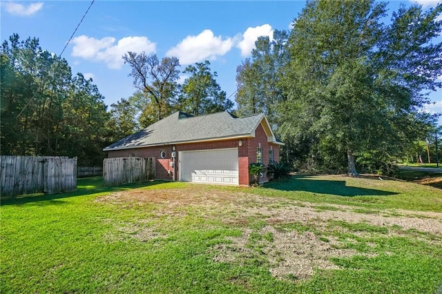 view of side of home with a garage and a lawn