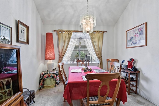 dining room featuring carpet flooring and a chandelier