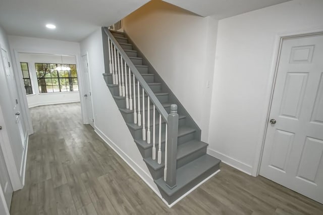 stairs featuring wood-type flooring