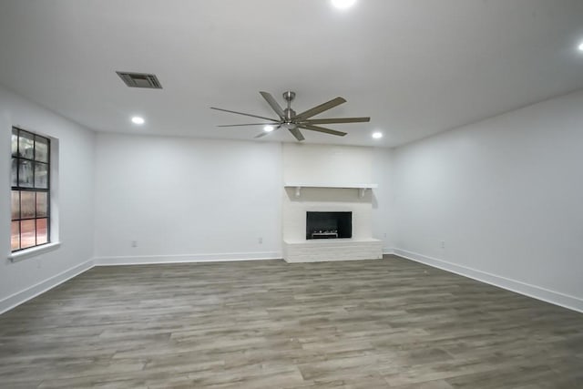 unfurnished living room with wood-type flooring and ceiling fan