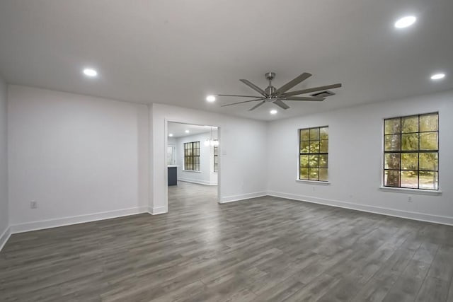 empty room with ceiling fan and dark wood-type flooring