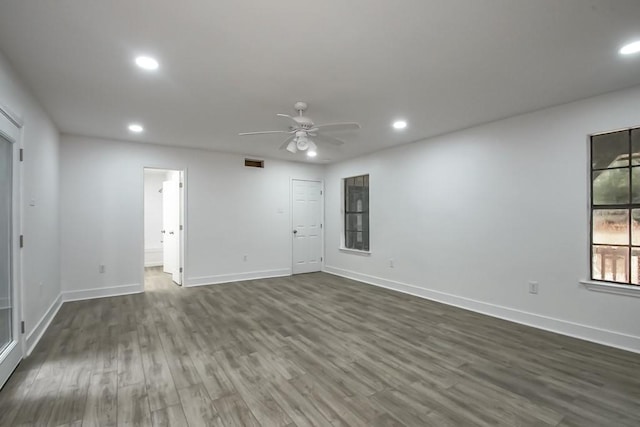 unfurnished room featuring ceiling fan and dark wood-type flooring