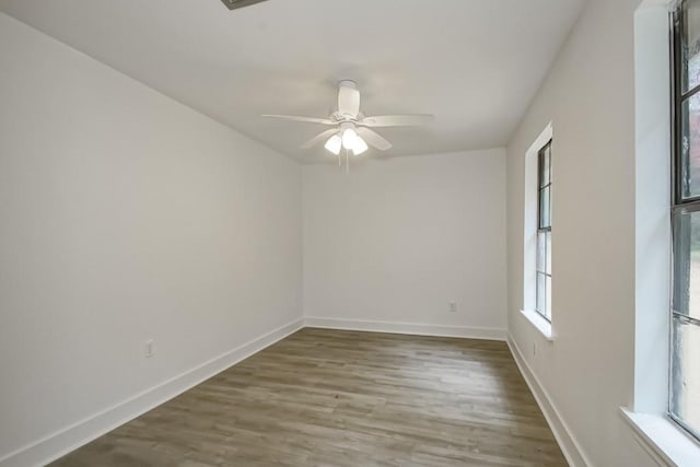 spare room featuring wood-type flooring and ceiling fan