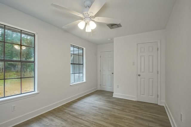 unfurnished bedroom with ceiling fan and wood-type flooring