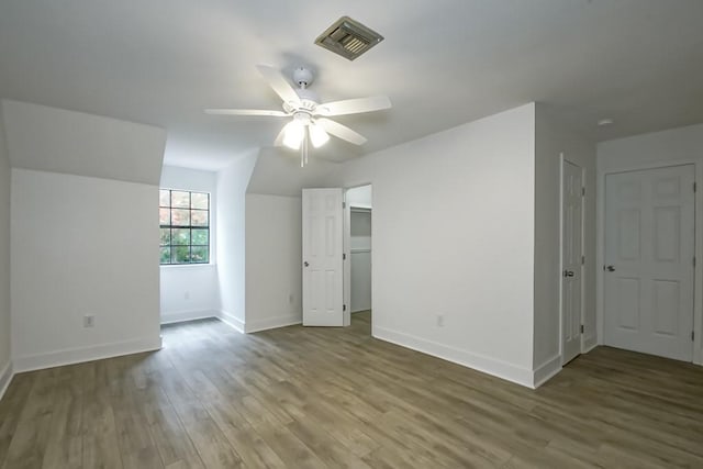 interior space with hardwood / wood-style floors and ceiling fan