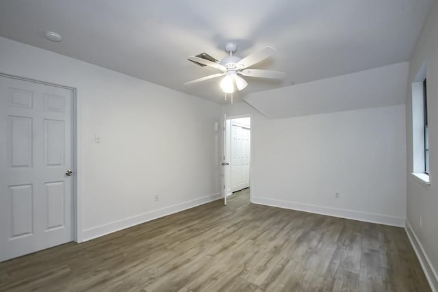 unfurnished room with ceiling fan and wood-type flooring