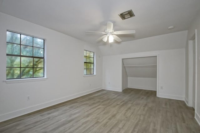 unfurnished bedroom with ceiling fan, a closet, and light hardwood / wood-style floors