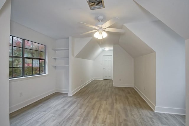 bonus room featuring light wood-type flooring, vaulted ceiling, and ceiling fan