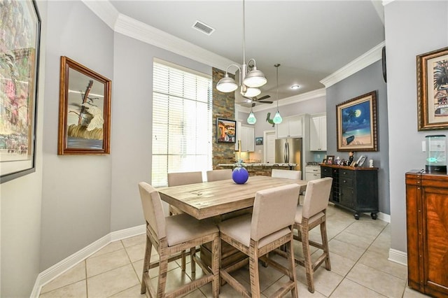 dining room with crown molding, ceiling fan, and light tile patterned floors