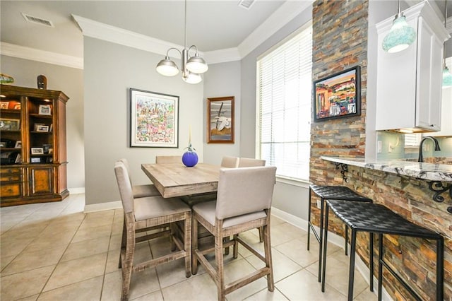 dining room featuring light tile patterned floors, ornamental molding, and a chandelier