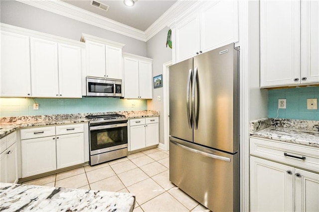 kitchen featuring white cabinetry, light tile patterned floors, crown molding, and stainless steel appliances