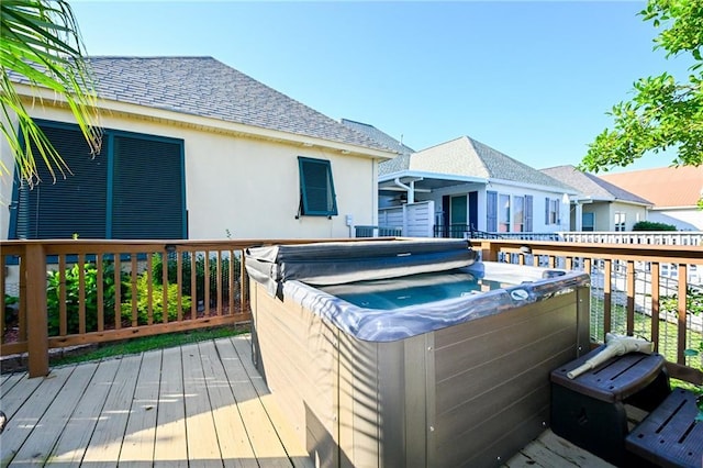 wooden terrace featuring a hot tub