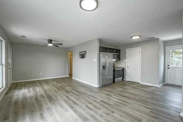 unfurnished living room featuring light hardwood / wood-style floors and ceiling fan