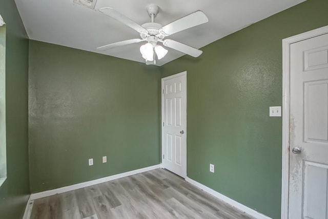 empty room featuring ceiling fan and light hardwood / wood-style flooring