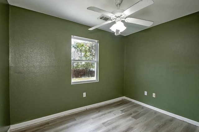 spare room featuring hardwood / wood-style flooring and ceiling fan