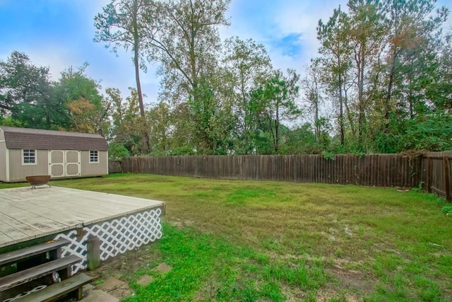 view of yard with a storage unit and a wooden deck