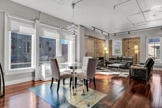 dining room featuring plenty of natural light, dark hardwood / wood-style floors, and track lighting