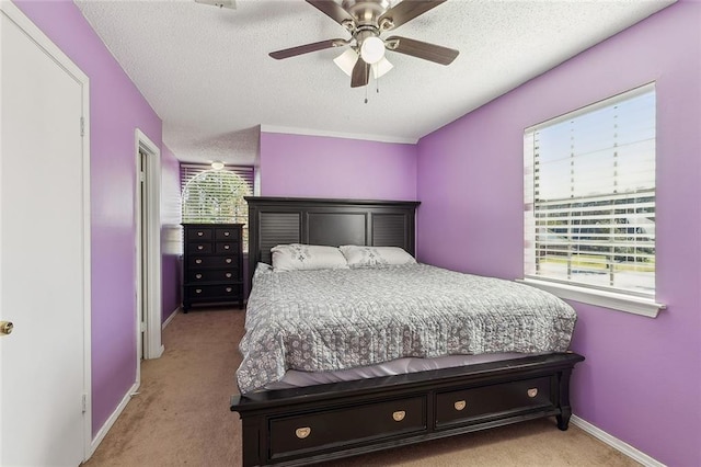 bedroom featuring multiple windows, light colored carpet, and ceiling fan