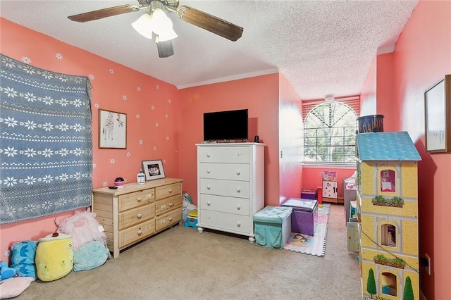 rec room featuring ceiling fan, carpet, and a textured ceiling