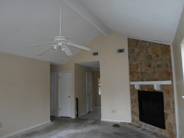 unfurnished living room with a fireplace, lofted ceiling with beams, ceiling fan, and carpet flooring