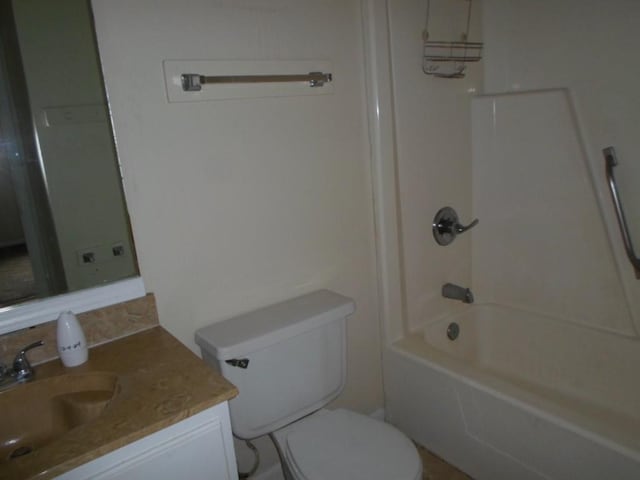 full bathroom with shower / tub combination, vanity, and toilet