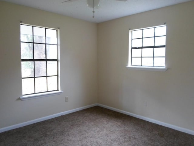 carpeted spare room with ceiling fan and a healthy amount of sunlight