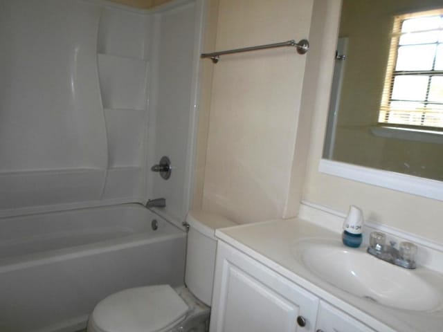 full bathroom with bathing tub / shower combination, vanity, and toilet