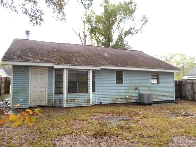 rear view of property with central AC