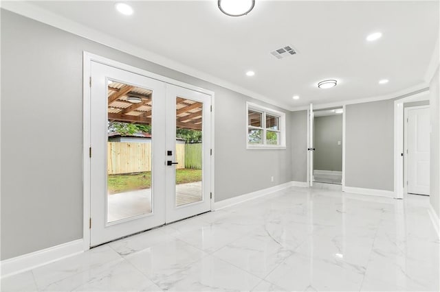 doorway with crown molding and french doors