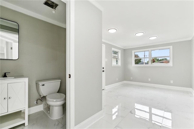 bathroom featuring vanity, toilet, and ornamental molding