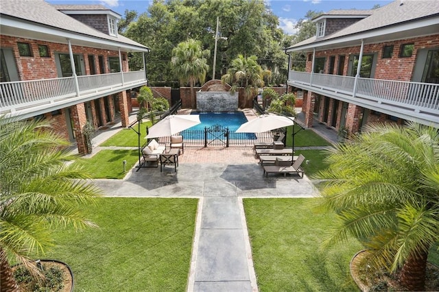 view of swimming pool featuring a patio area and a yard