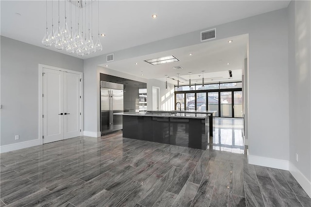 unfurnished living room with expansive windows and sink