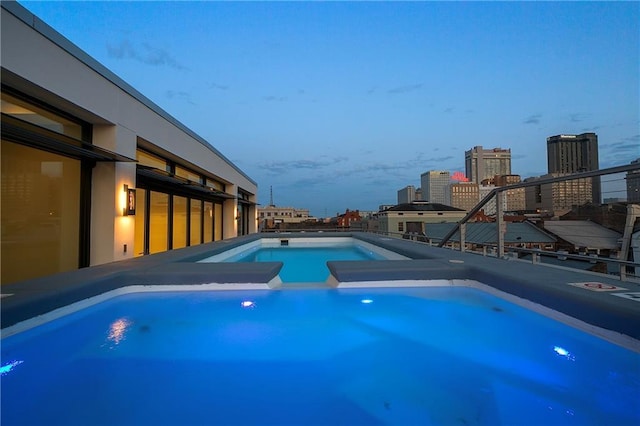 view of pool at dusk