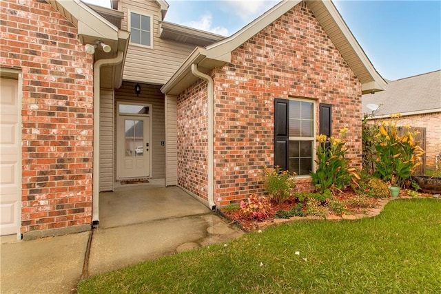 entrance to property with a lawn