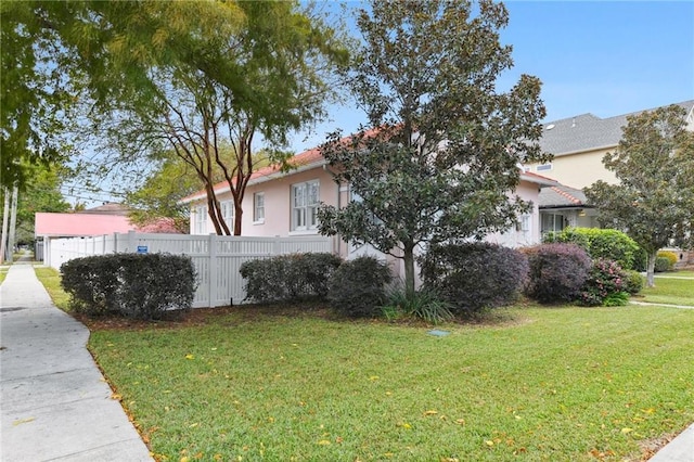 view of side of property with a yard