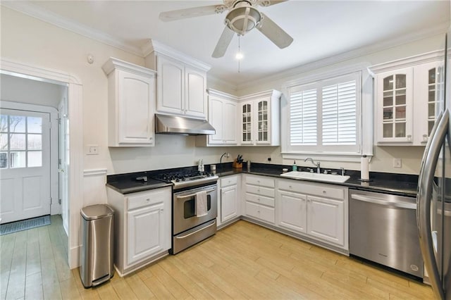 kitchen with white cabinets, stainless steel appliances, light hardwood / wood-style flooring, and sink