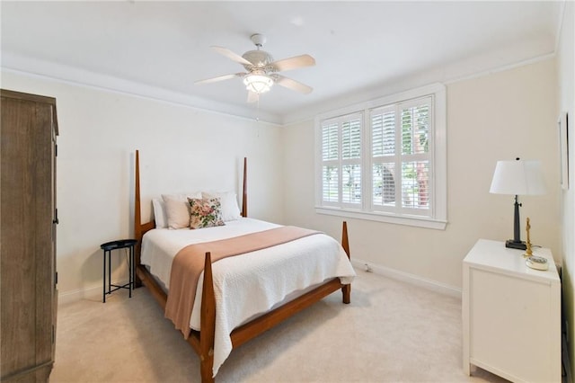 bedroom featuring light carpet, ceiling fan, and crown molding