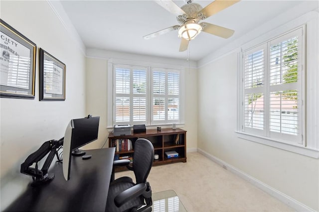 office area with ceiling fan, a healthy amount of sunlight, crown molding, and light carpet