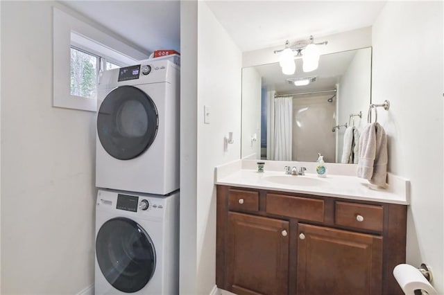 laundry area featuring stacked washer / dryer and sink