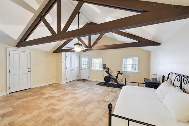 exercise room with high vaulted ceiling and ceiling fan