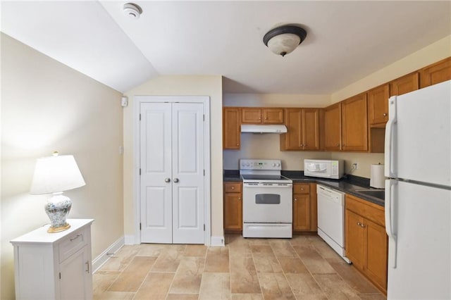 kitchen featuring white appliances and vaulted ceiling