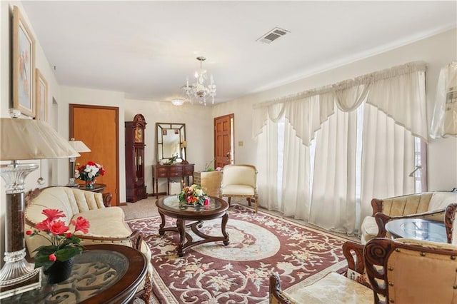 living area featuring carpet flooring and a notable chandelier