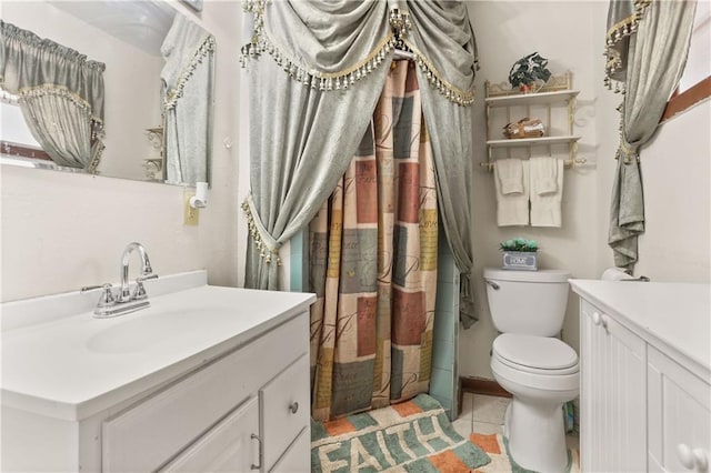 bathroom featuring tile patterned floors, vanity, and toilet