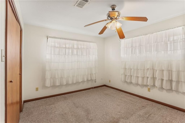 carpeted empty room featuring ceiling fan