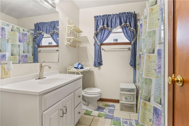 bathroom featuring tile patterned flooring, vanity, and toilet